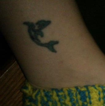 Illustration for article titled My poor sad dolphin tattoo got a face-lift